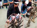 年街节上白裤瑶展示纺纱技艺（摄影：陈丽娜）