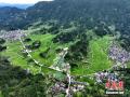 7月19日，无人机航拍的广西三江侗族自治县良口乡南寨村、和里村，稻田景美如画。大暑将至，当地稻田绿意盎然、线条优美，与周边的特色民居、曲折道路相互映衬，构成一幅幅迷人的夏日田园画卷。图为当地稻田风光。（图/龚普康）